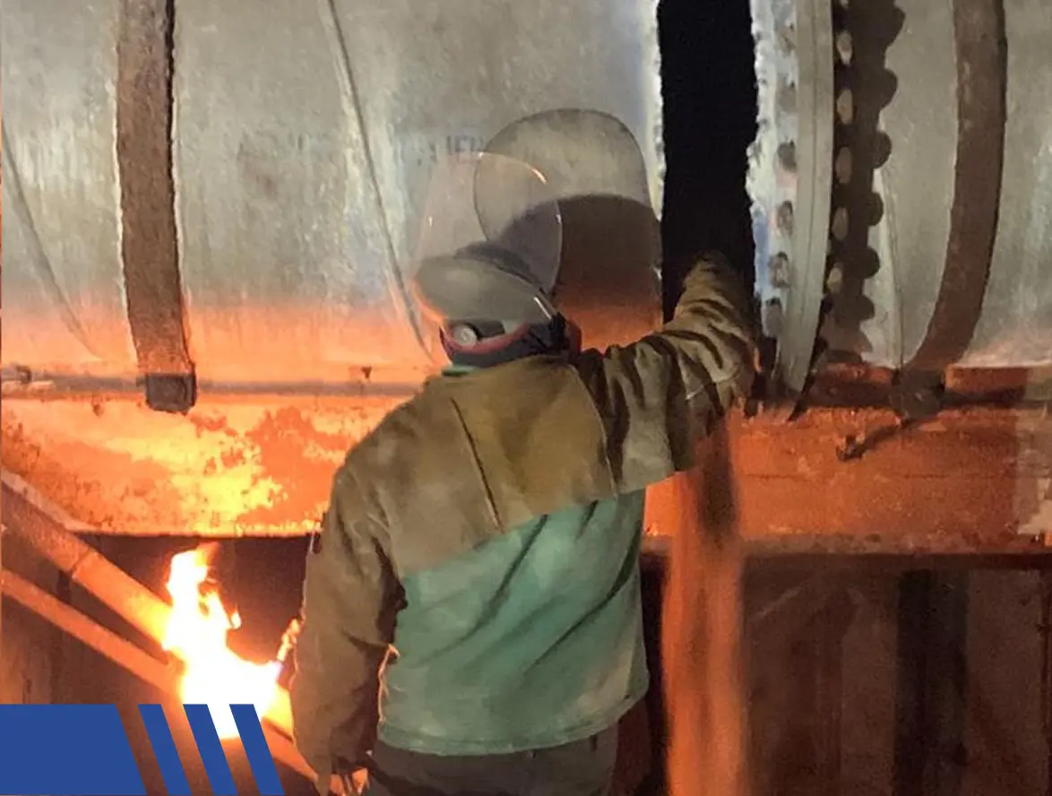 inspecting a boiler in midst of torching Safe Handling of Full Building Removal